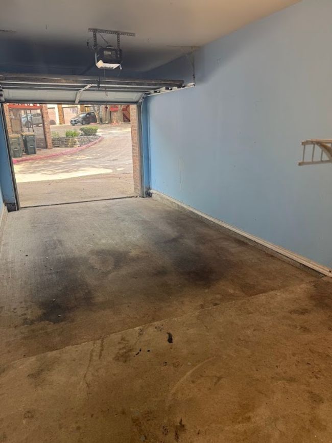 Garage featuring a garage door opener and baseboards | Image 28