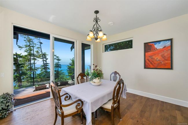 Dining area featuring a chandelier and dark wood-style floors | Image 42