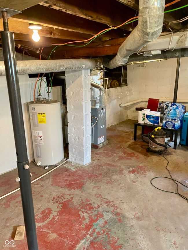 unfinished basement featuring water heater | Image 24