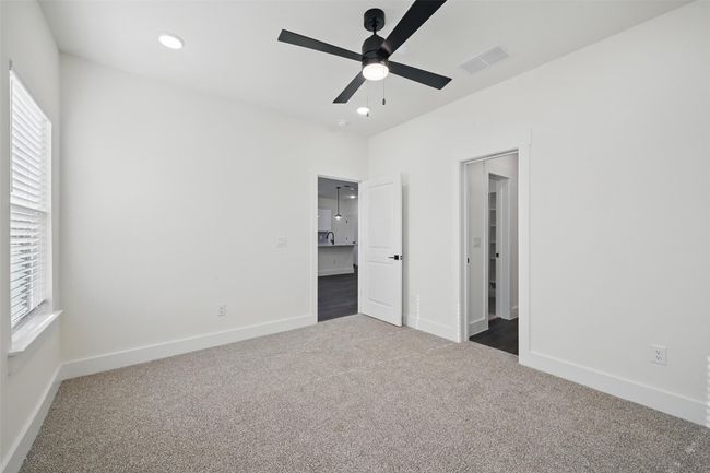 Unfurnished bedroom with visible vents, baseboards, ceiling fan, recessed lighting, and dark colored carpet | Image 18