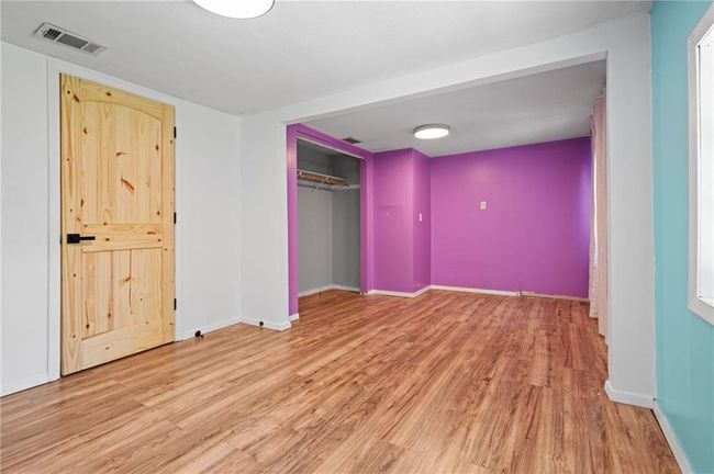 Unfurnished bedroom featuring wood finished floors and a closet | Image 14