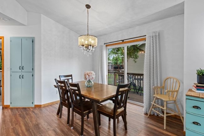 The dining room is spacious and walks out to the deck. Perfect for summer grilling! There's an additional deep storage cabinet for the kitchen or bathroom in the closet to the left. | Image 9