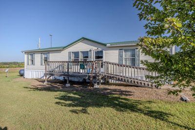 Rear view of property with a wooden deck and a lawn | Image 2