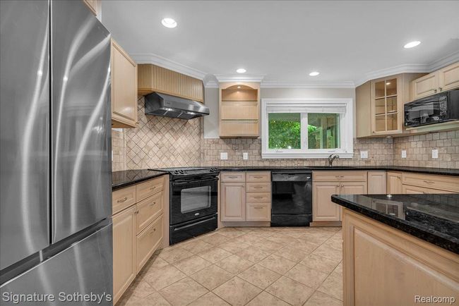 Kitchen with Indoor Grill, Peninsula Island, Granite Counters & Maple Cabinets | Image 12