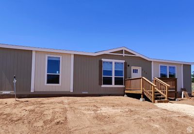 Front view of house featuring a wooden deck | Image 1