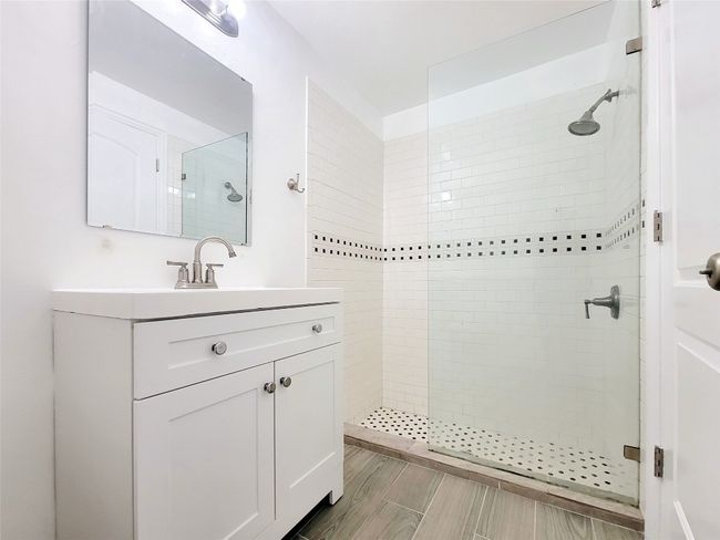 Full bath featuring a tile shower and vanity | Image 9