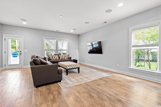 Living room with healthy amount of natural light, light wood-style floors, and recessed lighting | Image 20