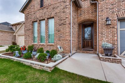 View of exterior entry featuring bricked landscaping | Image 3