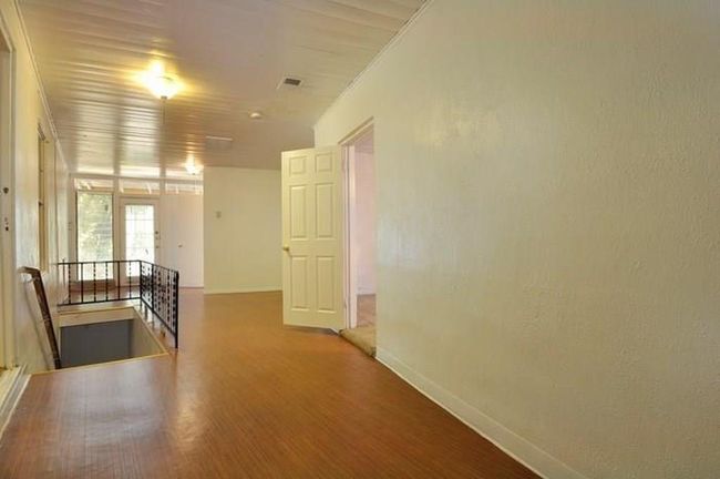 Spare room featuring baseboards and wood finished floors | Image 5
