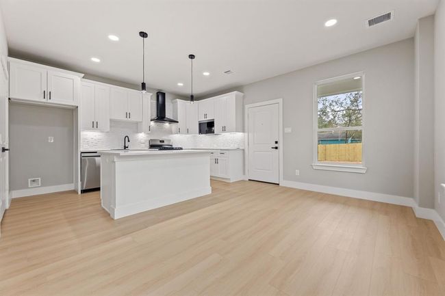 Connected living and dining. The open floor plan allows for easy flow from the kitchen to the living anddining areas, ideal for hosting guests. | Image 4