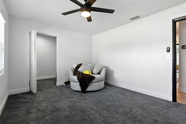 The front bedroom offers generous natural light, a spacious layout, and an oversized walk-in closet ready for your custom storage vision | Image 27