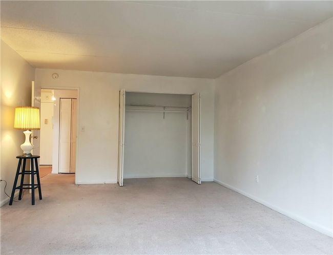 Unfurnished bedroom featuring light carpet and a closet | Image 8