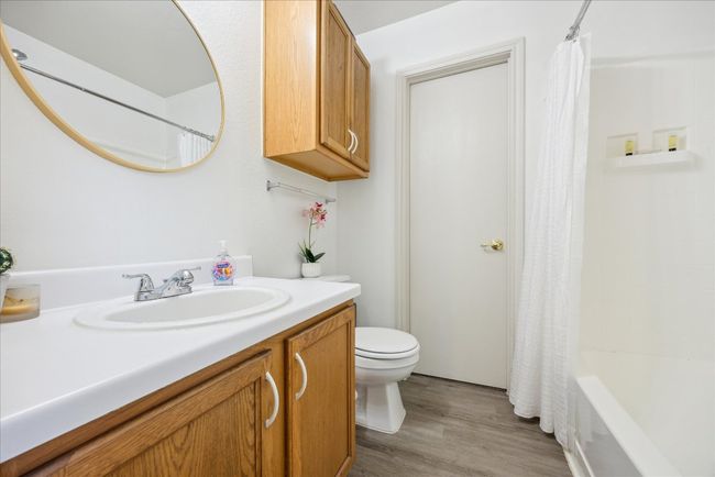 Full bathroom with vanity, wood finished floors, and shower / tub combo | Image 6
