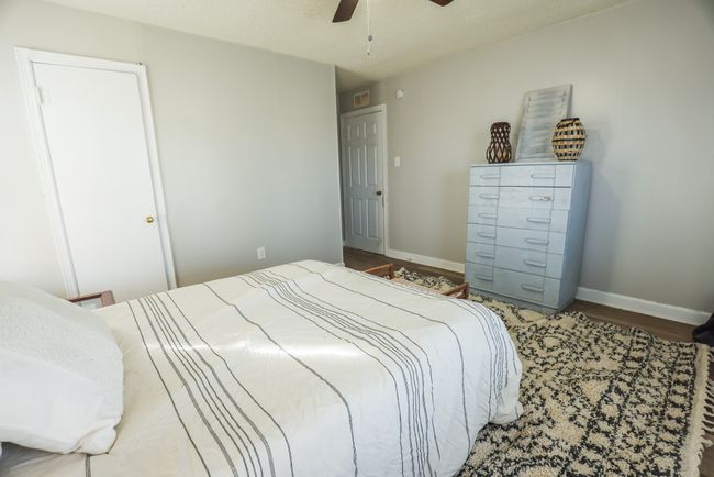 Bedroom featuring ceiling fan, baseboards, and wood finished floors | Image 22