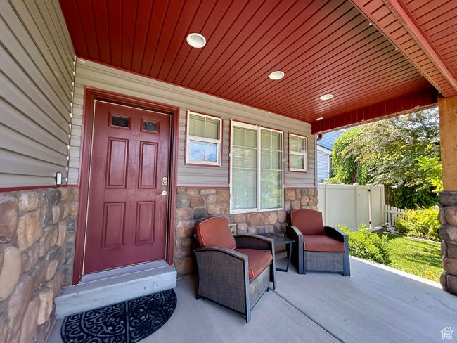 Entrance to property featuring stone siding and covered porch | Image 6