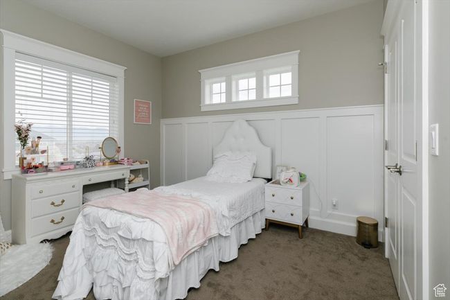 Carpeted bedroom with a decorative wall and a wainscoted wall | Image 39