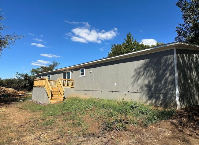 Back of house with a wooden deck and stairs | Image 4