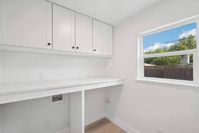 Washroom featuring cabinet space, light wood-style floors, and hookup for a washing machine | Image 28