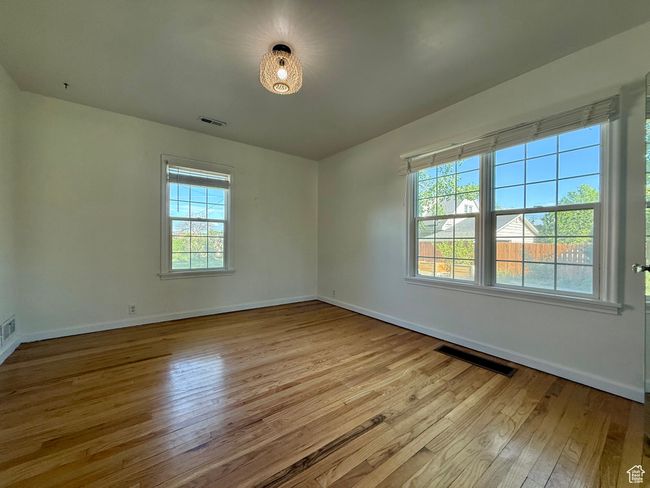 Unfurnished room with hardwood / wood-style flooring and baseboards | Image 19