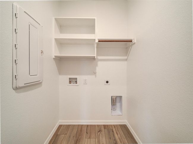 Washroom with wood finished floors, electric dryer hookup, baseboards, hookup for a washing machine, and hookup for a gas dryer | Image 34