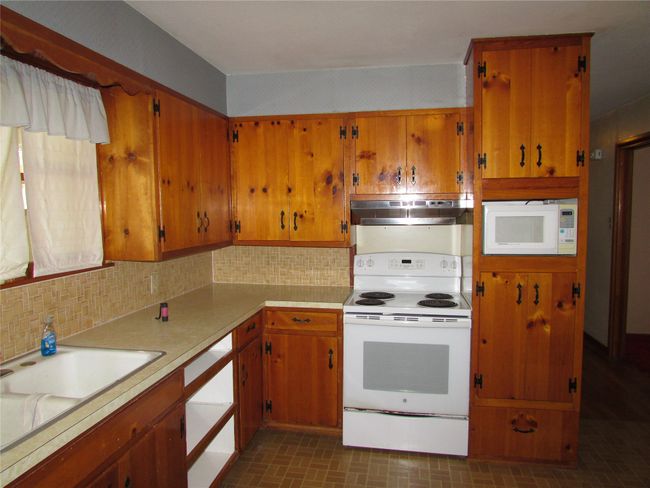 Kitchen with knotty pine cabinets | Image 6