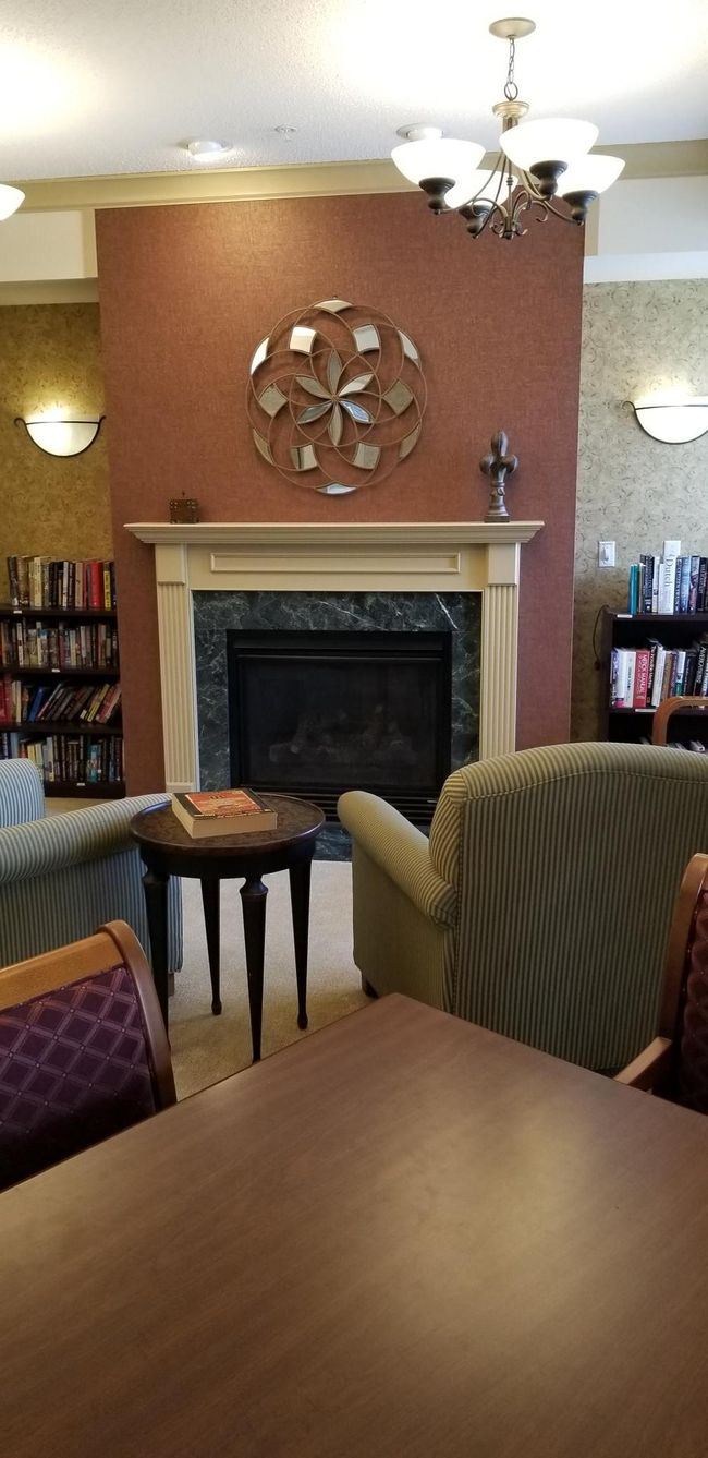 Library features a cozy fireplace. | Image 10