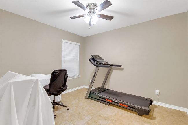 Exercise area with ceiling fan and baseboards | Image 14