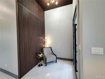 Sitting room featuring track lighting and light tile floors | Image 3