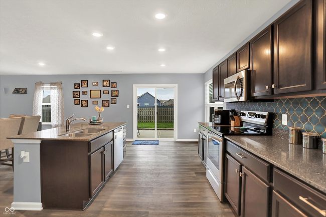 Windows and large sliding glass door provide ample light. | Image 13