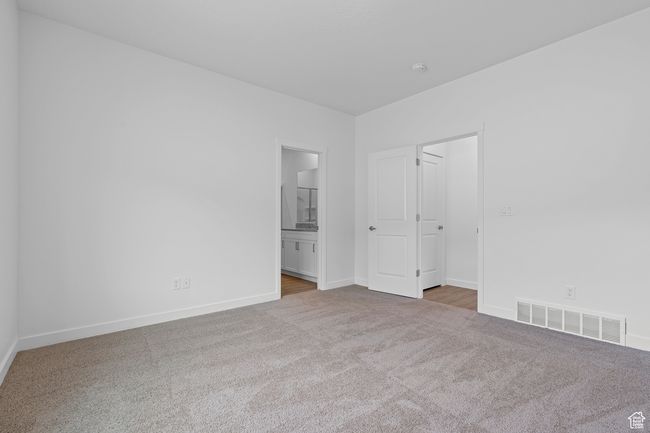 Carpeted empty room with visible vents and baseboards | Image 9
