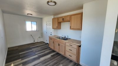 Kitchen with sink, dark hardwood / wood-style floors, and light brown cabinets | Image 2