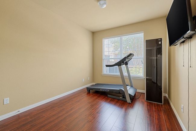 Exercise room with wood finished floors and baseboards | Image 26