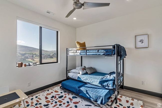 Bedroom with recessed lighting, visible vents, ceiling fan, wood finished floors, and baseboards | Image 51