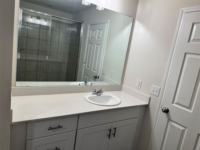 Bathroom featuring vanity, a stall shower, and a textured wall | Image 17