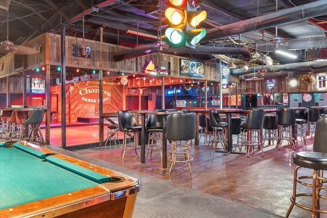 Game room with a dry bar, billiards, and concrete floors | Image 9