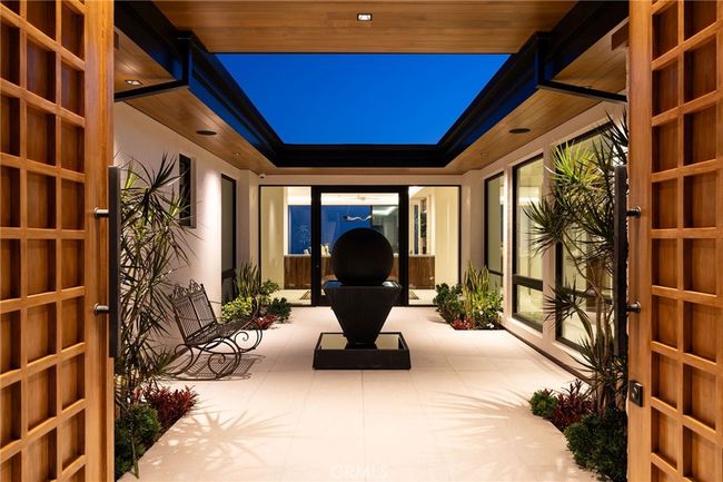 Enclosed entry courtyard with engineered cedar soffit and an artistic center fountain. Direct entrance to the private casita can be found on the left. | Image 36