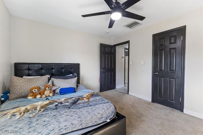 Carpeted bedroom featuring visible vents, a ceiling fan, and baseboards | Image 20