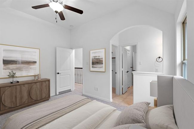 This spacious bedroom features a bright window for natural light, a high sloped ceiling, and a ceiling fan for added comfort and air circulation. *Virtually Staged* | Image 18