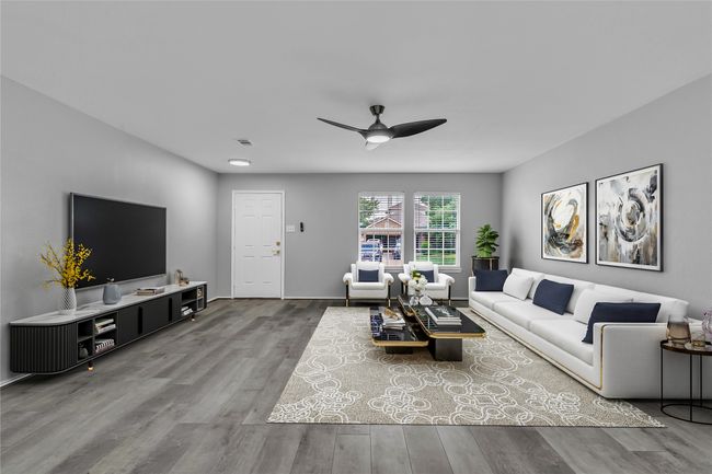 Living area featuring wood finished floors, a ceiling fan, and baseboards | Image 7
