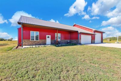 View of front of property featuring a garage and a front yard | Image 3