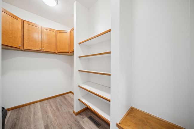 Conveniently located off the garage, the mudroom offers the perfect drop zone with built-in shelving and cabinets to keep shoes, coats, sporting equipment, and everyday essentials organized and out of sight. | Image 20