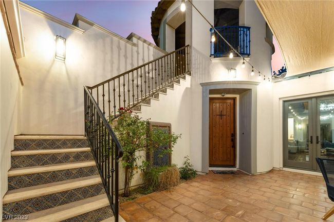 Staircase to casita with portico overlooking the courtyard. Main entrance to home below portico. | Image 26