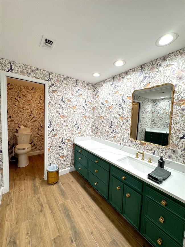 Bathroom featuring toilet, vanity, and wood-type flooring | Image 23