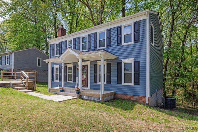 Colonial house with a front lawn, central AC unit, a chimney, covered porch, and crawl space | Image 32