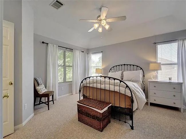 Bedroom featuring light colored carpet and a ceiling fan | Image 16
