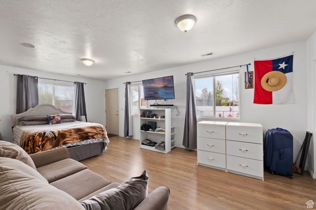 Bedroom with light wood-type flooring and visible vents | Image 41
