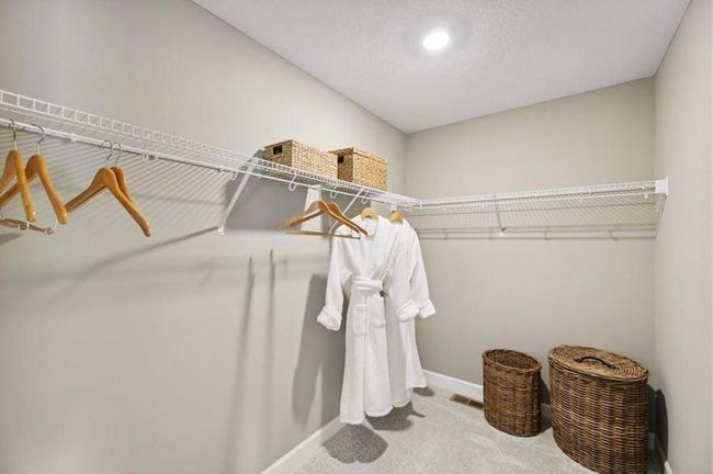 (Photo of decorated model, actual home finishes will vary) The primary bedroom features an incredible walk-in closet. | Image 17