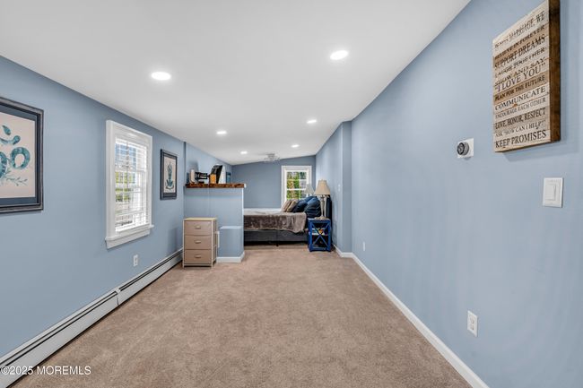 Primary bedroom has space for a sitting area or office | Image 20