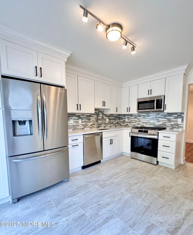 Beautiful white kitchen with porcelain tile, and stainless appliances | Image 5