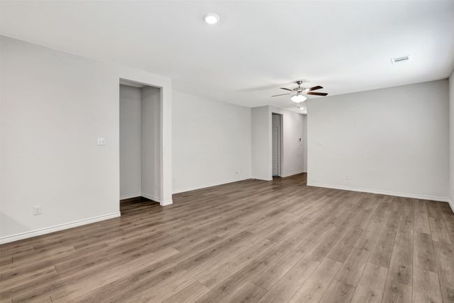 Unfurnished room with ceiling fan, wood finished floors, and recessed lighting | Image 16
